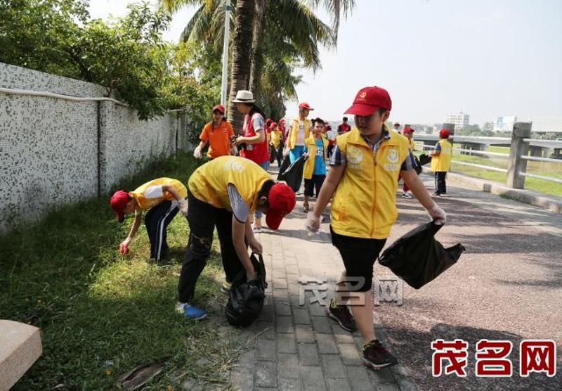 志愿者在小东江畔清洁环境卫生。茂名晚报记者岑稳 摄