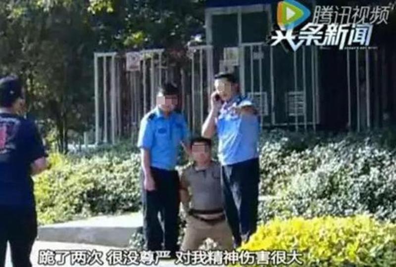 李先生被交警强行摔跪在马路中间。